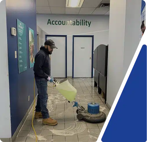 A cleaner mopping a hallway outside a room labeled "Accessibility", framed by a blue graphic.