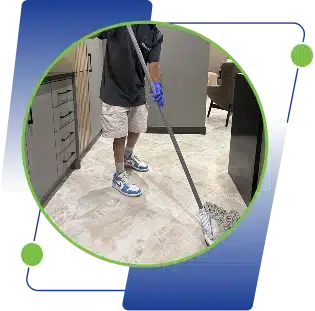 A person mopping a tiled hallway floor.