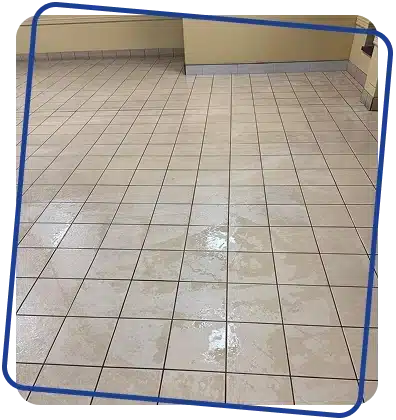 A clean, light-colored tiled floor in an empty room.