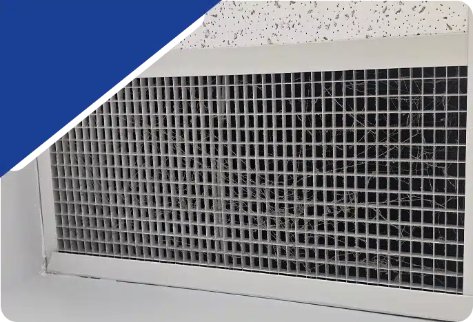 A close-up of a grid-style ceiling air vent, framed by a blue graphic.